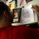 Here, a prisoner draws a fashion model from a photograph for Guimaraes.